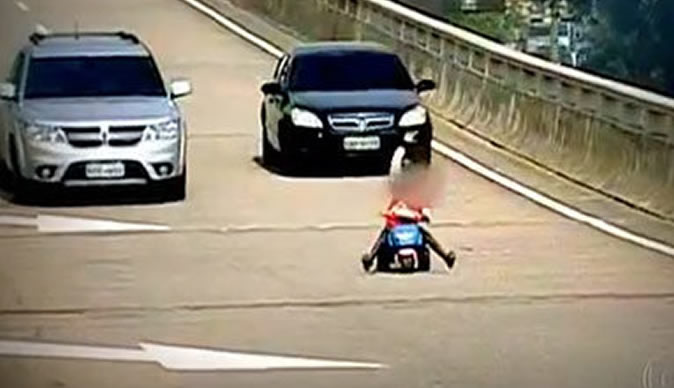 Eight-year-old boy rides tricycle on motorway